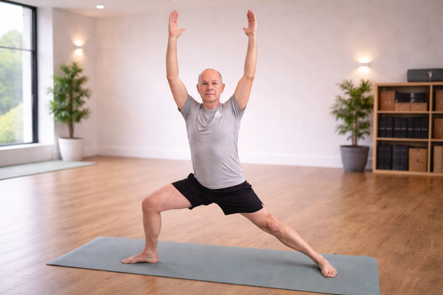 Nick Morley, a Pilates instructor, demonstrating a restorative spinal stretch during a session.